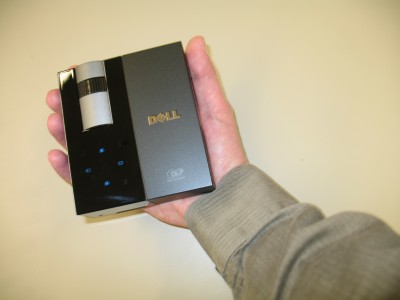 photo of Dell's small M109S projector in a person's hand